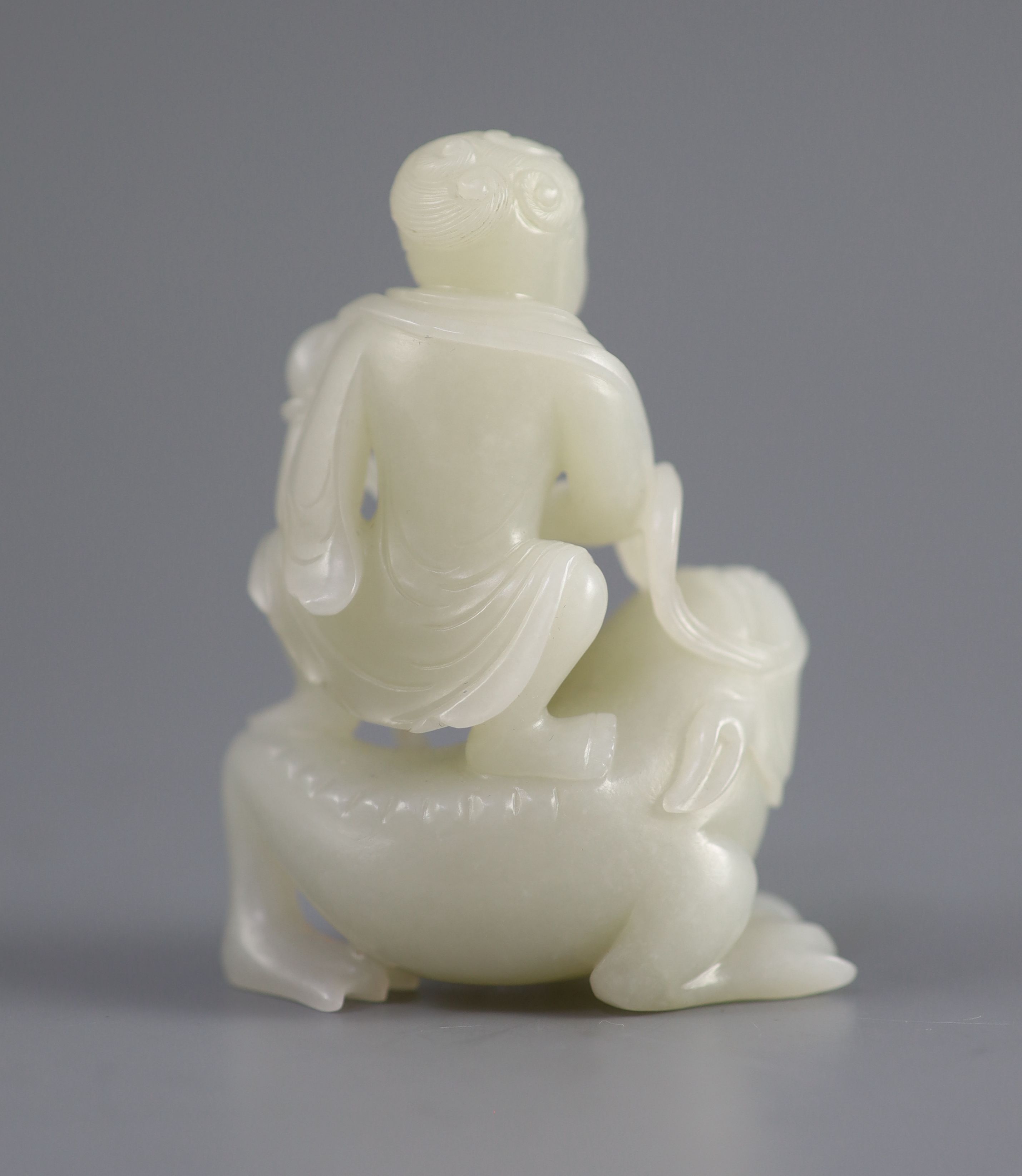 A good Chinese pale celadon jade group of Liu Hai and the three legged toad, 18th century, 8cm high, the wood stand carved with swirling waves